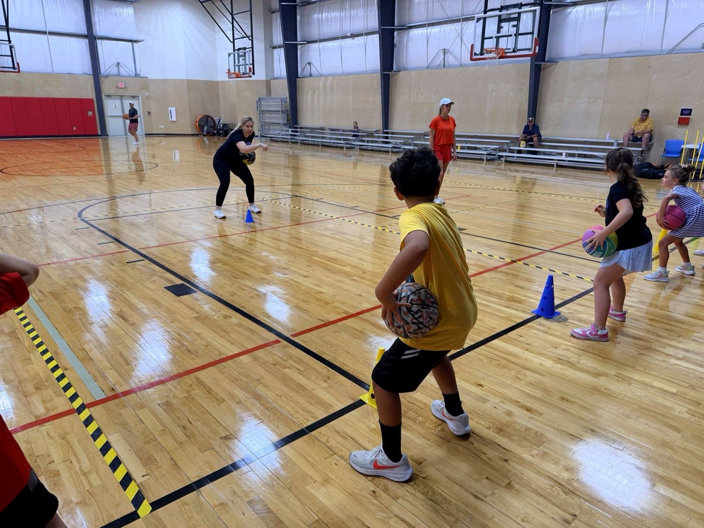 A Wildcats coach demonstrating a drill as players look on
