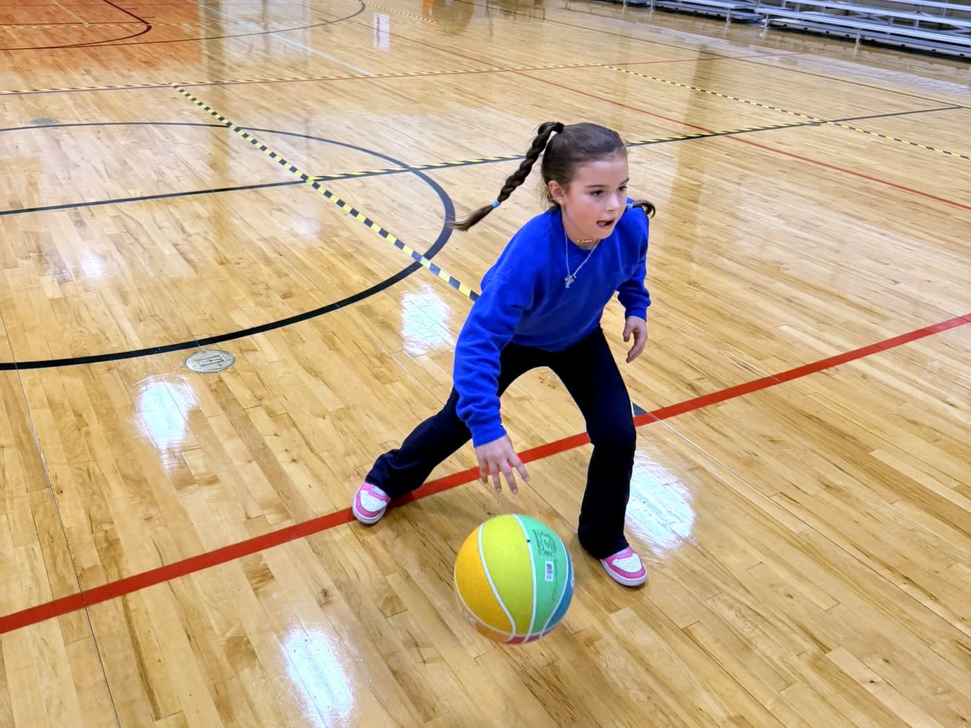 A young ATX Wildcats player driving in a low dribbling stance