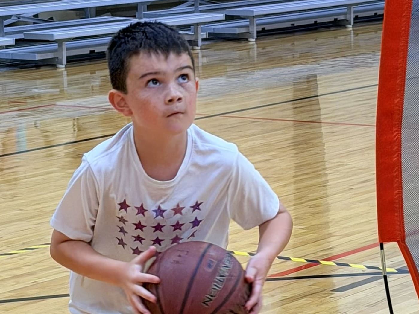 A young ATX Wildcats player squaring up to attack the basket
